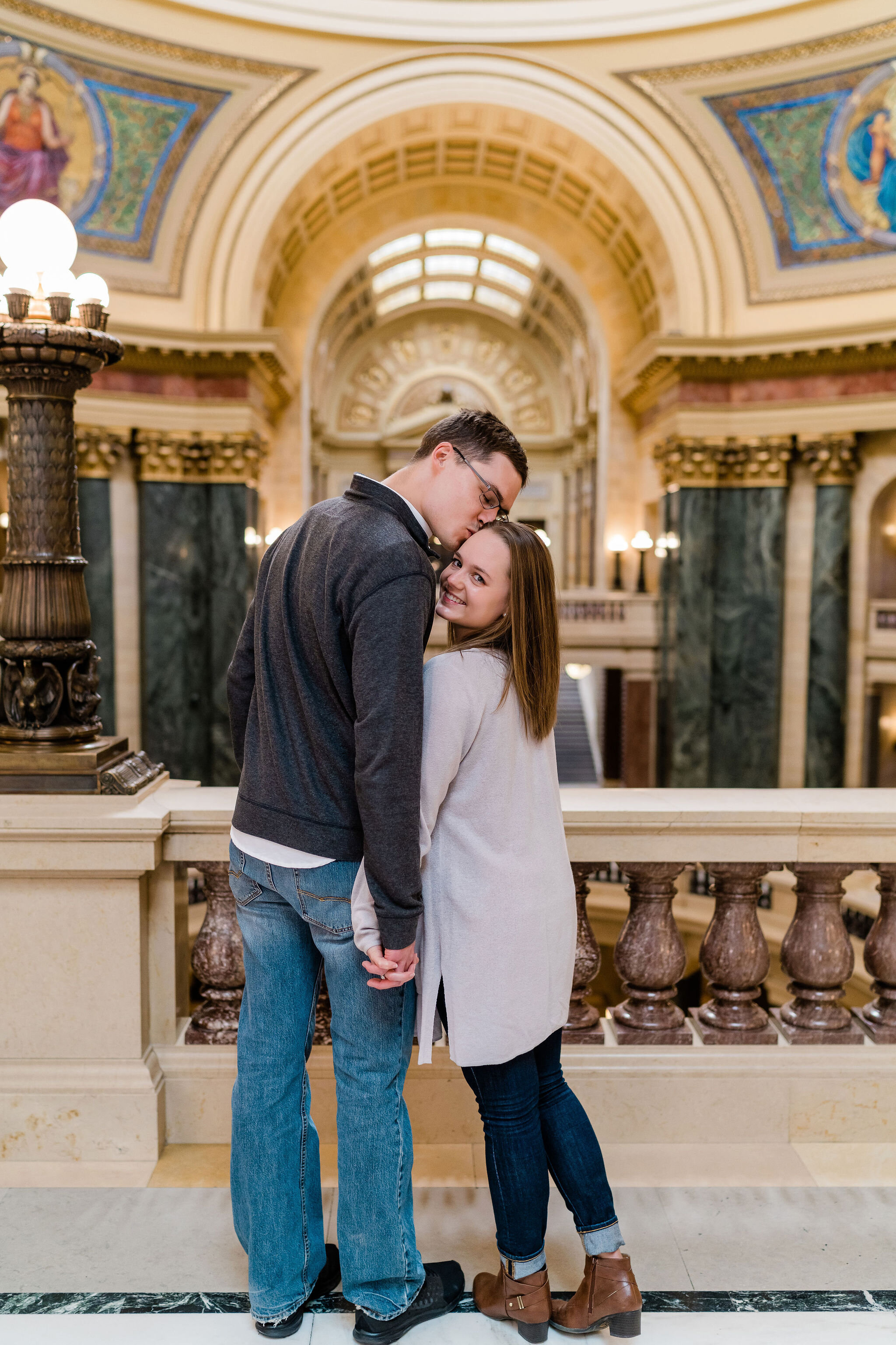 Engaged couple inside Wisconsin State Capitol in Madison, WI