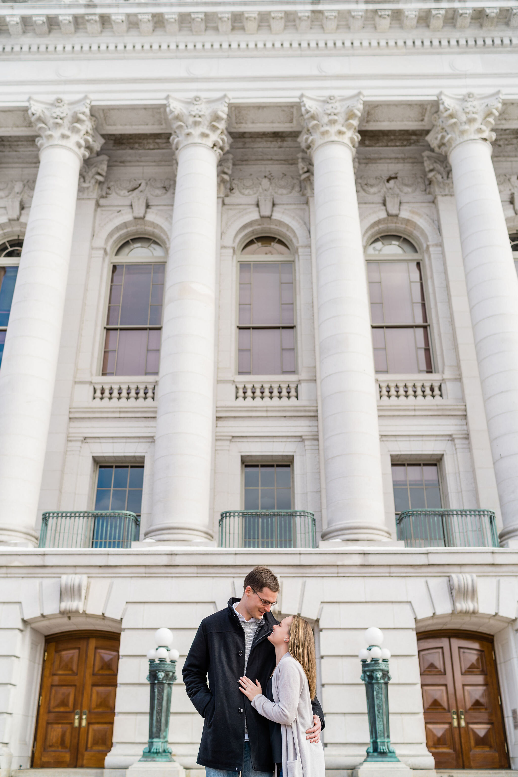 Engaged couple outside Wisconsin State Capitol in Madison, WI