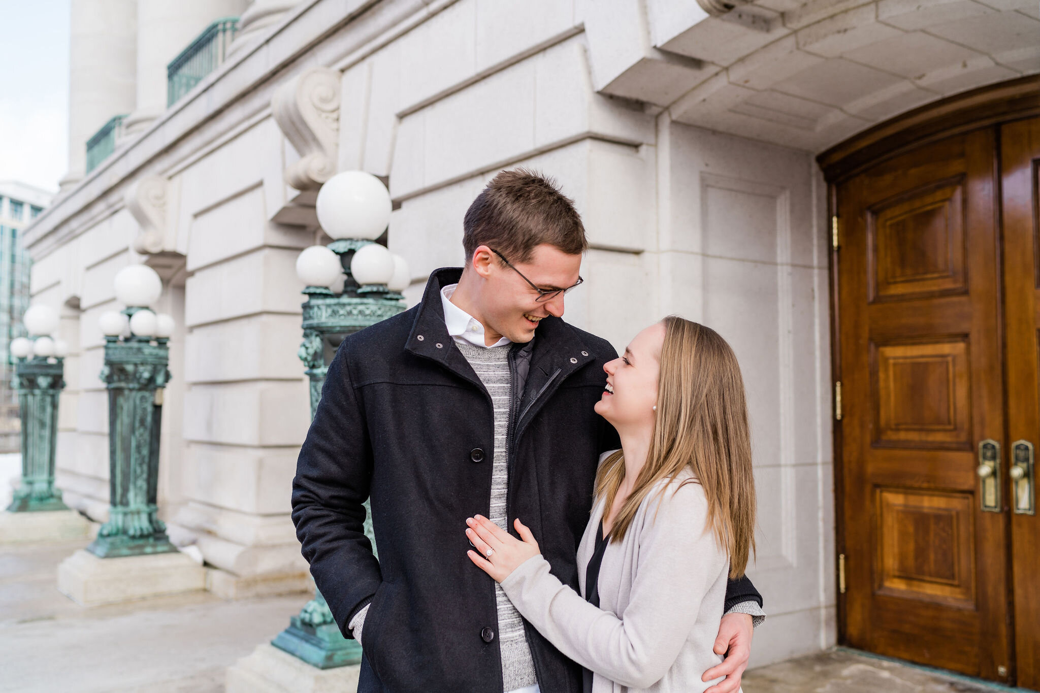 Engaged couple outside Wisconsin State Capitol in Madison, WI