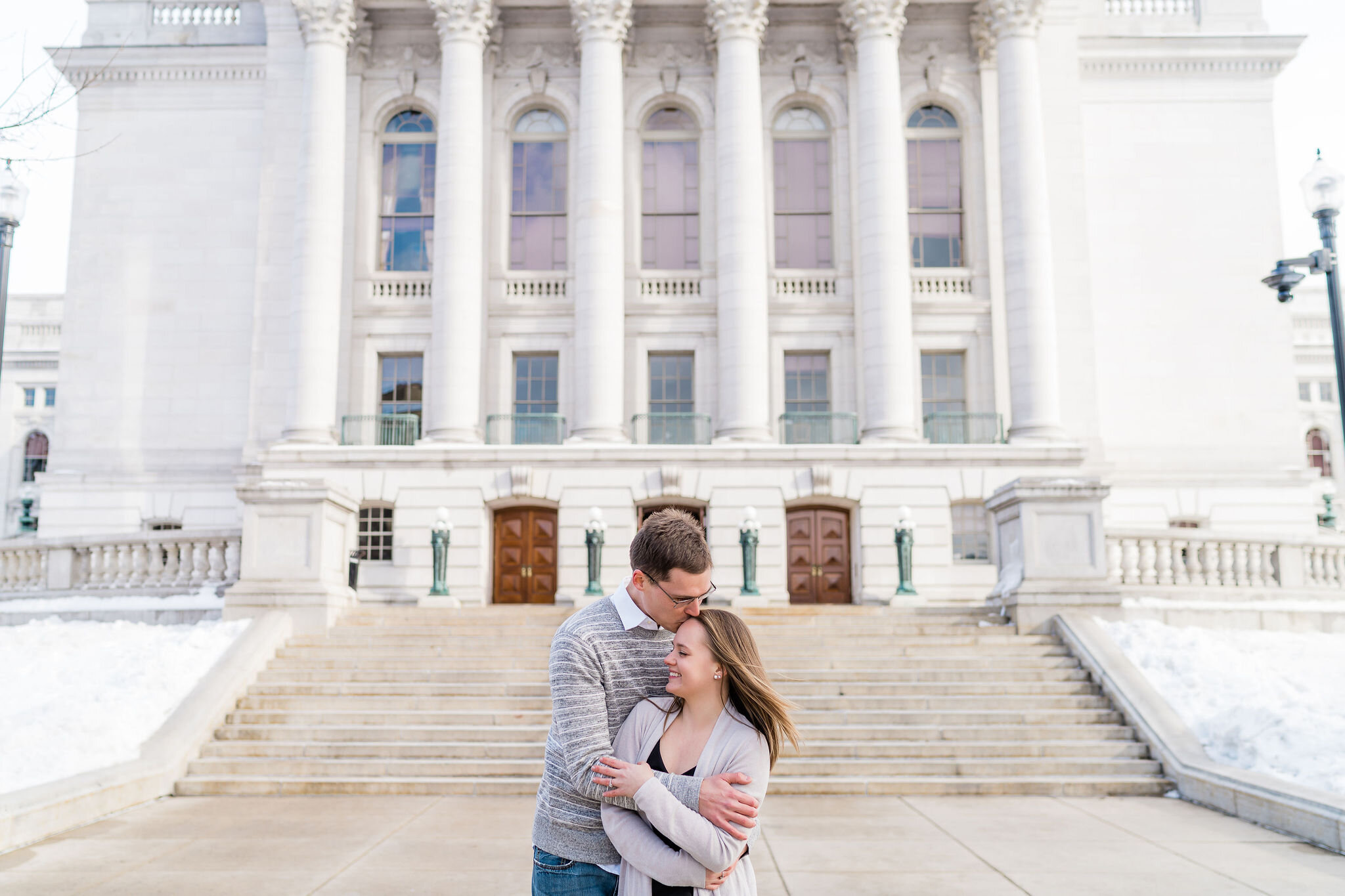 Engaged couple in front of Wisconsin State Capitol in Madison, WI