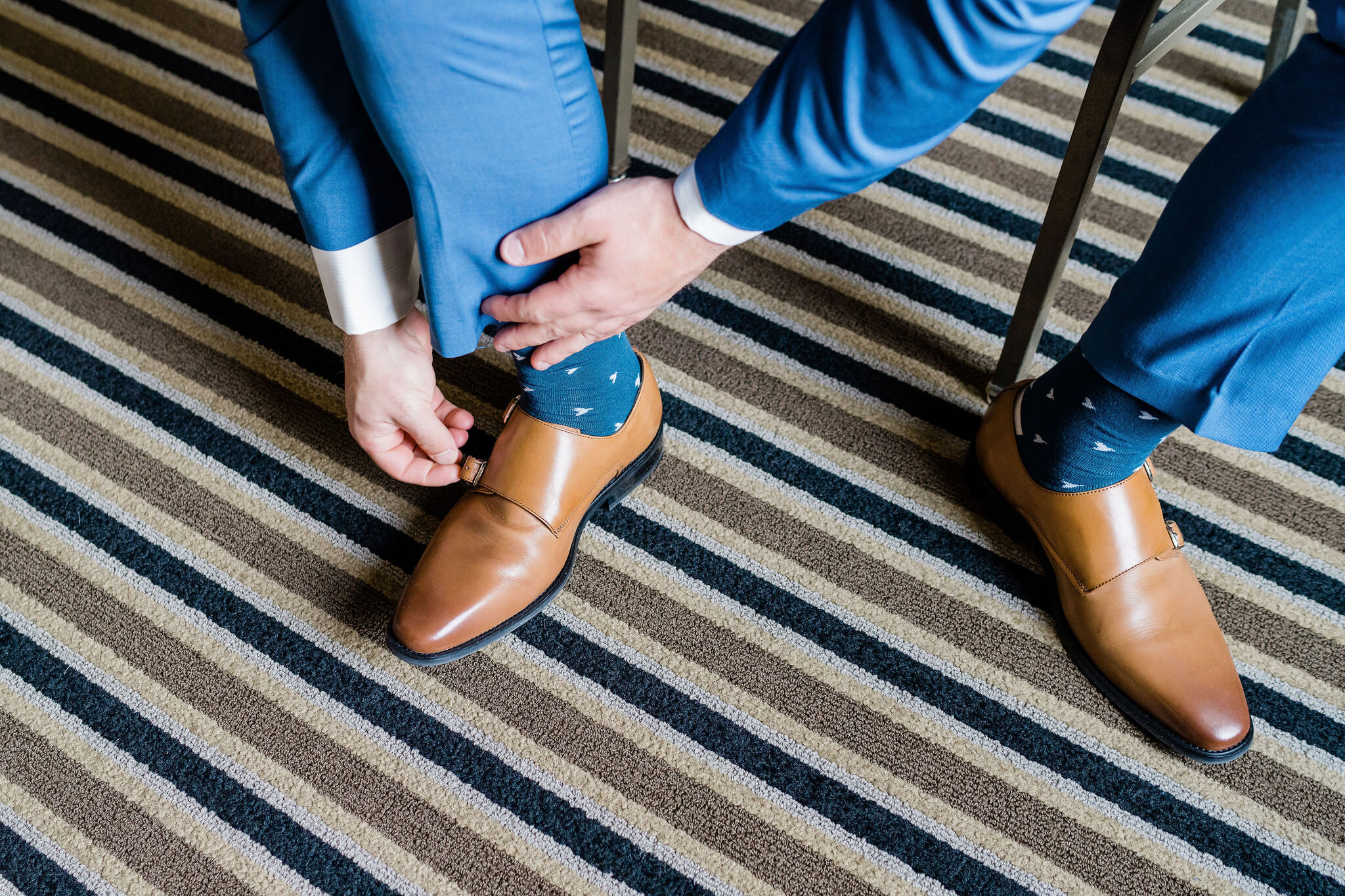 Groom putting his shoes on