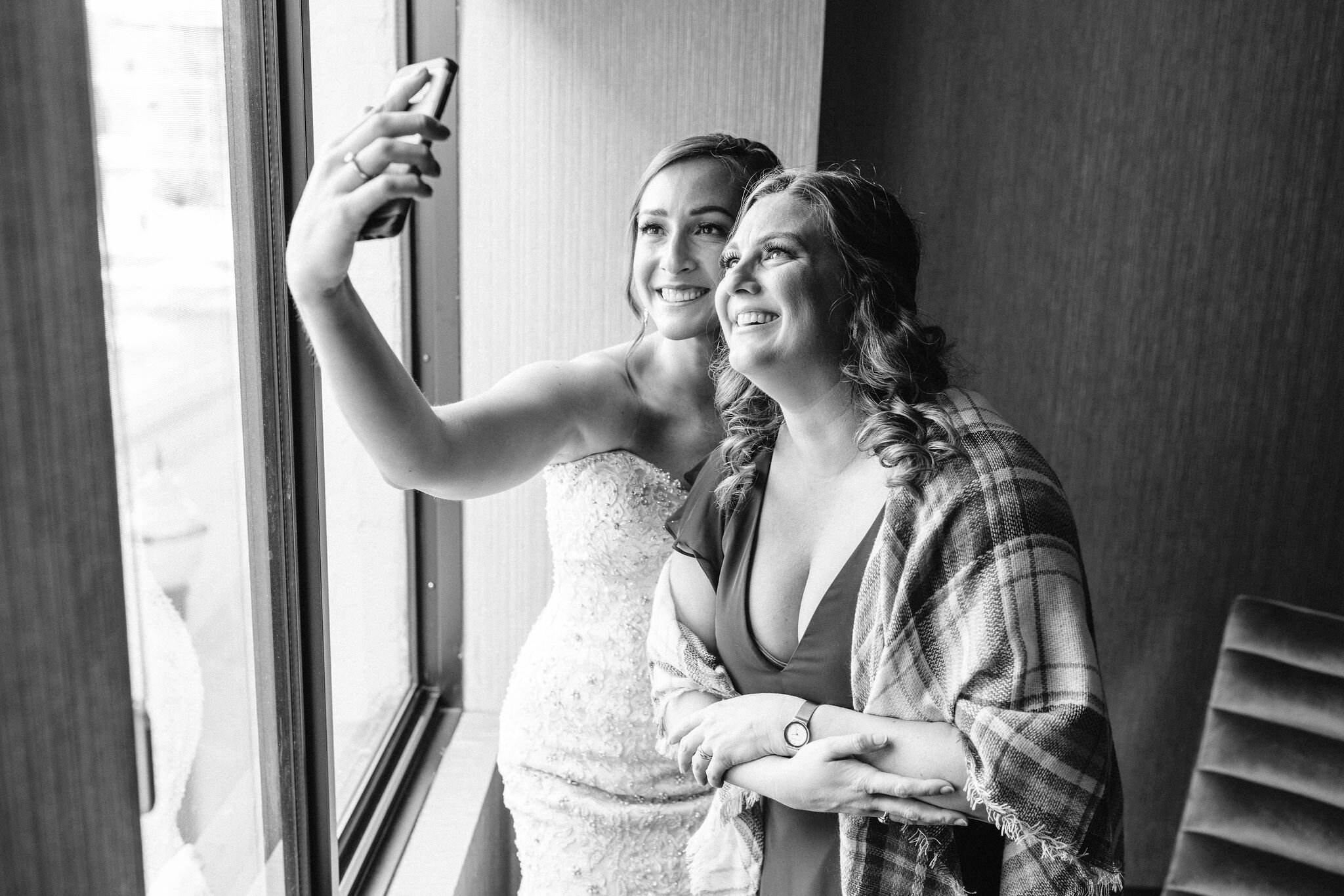 Bride and bridesmaid taking a selfie