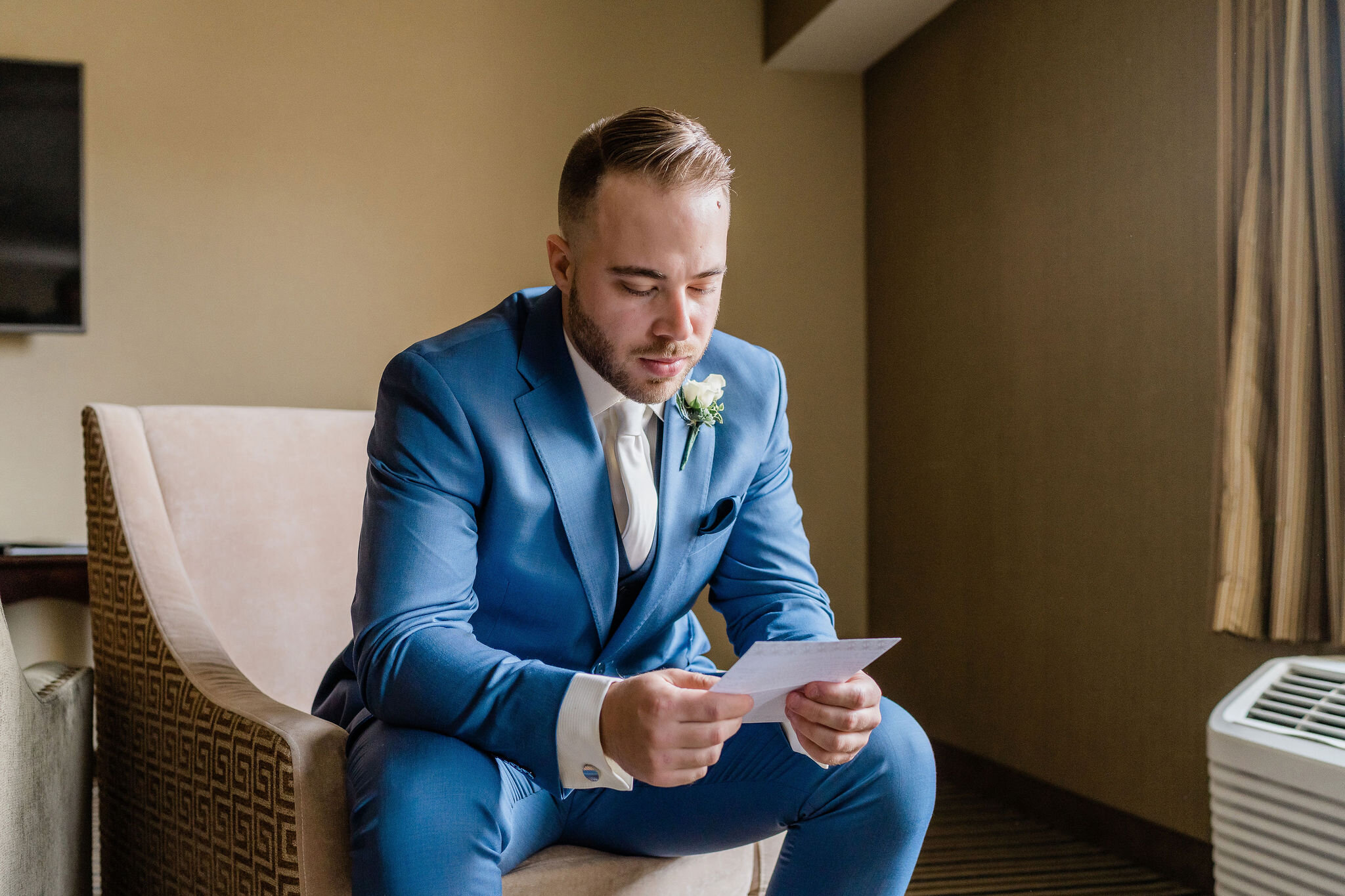 Groom reading a letter from the bride