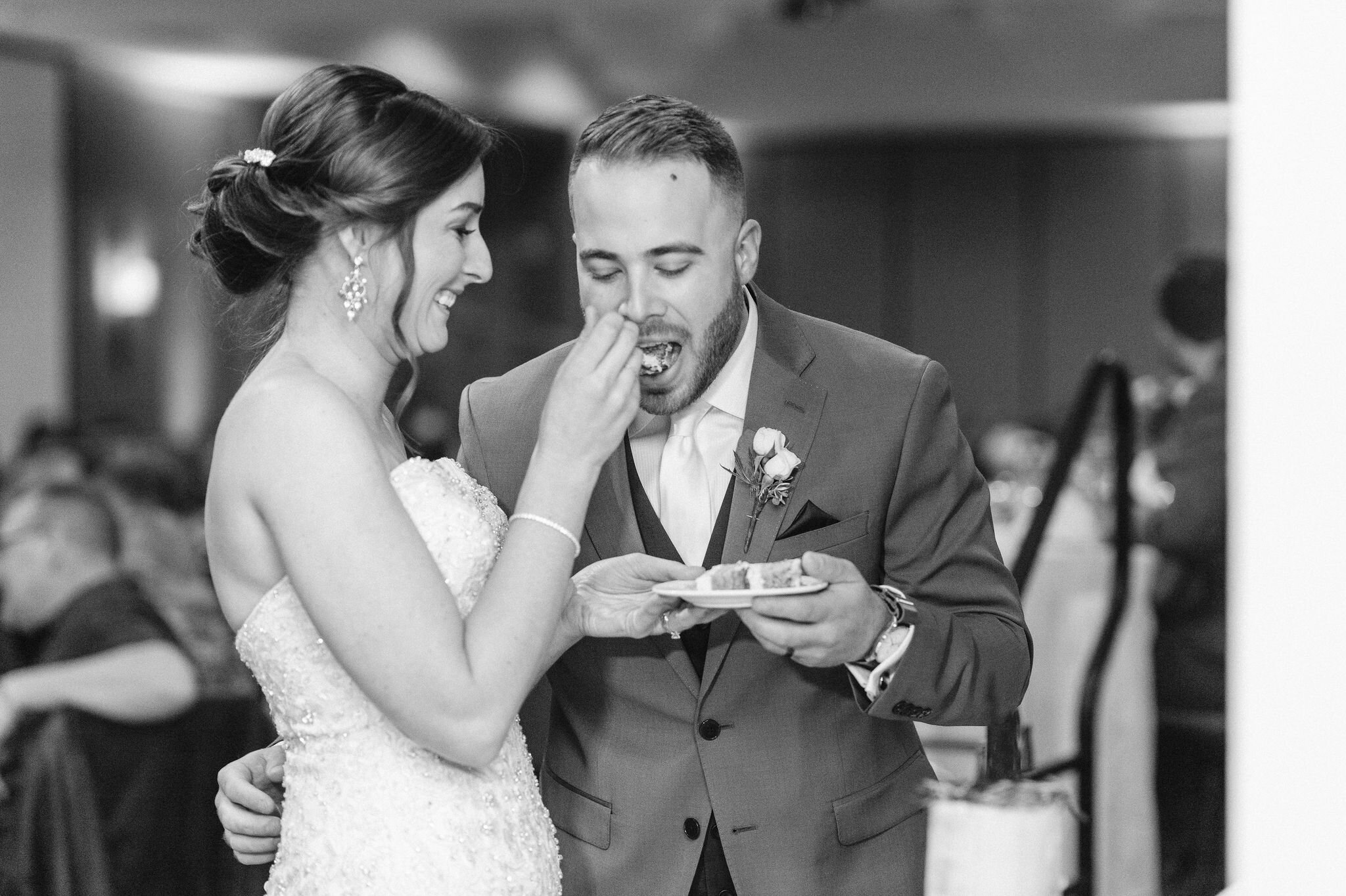 Bride feeding the groom cake