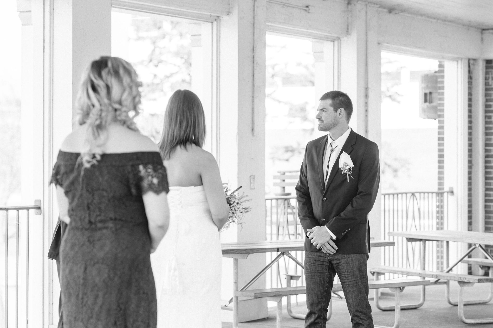 Groom looking at the officiant