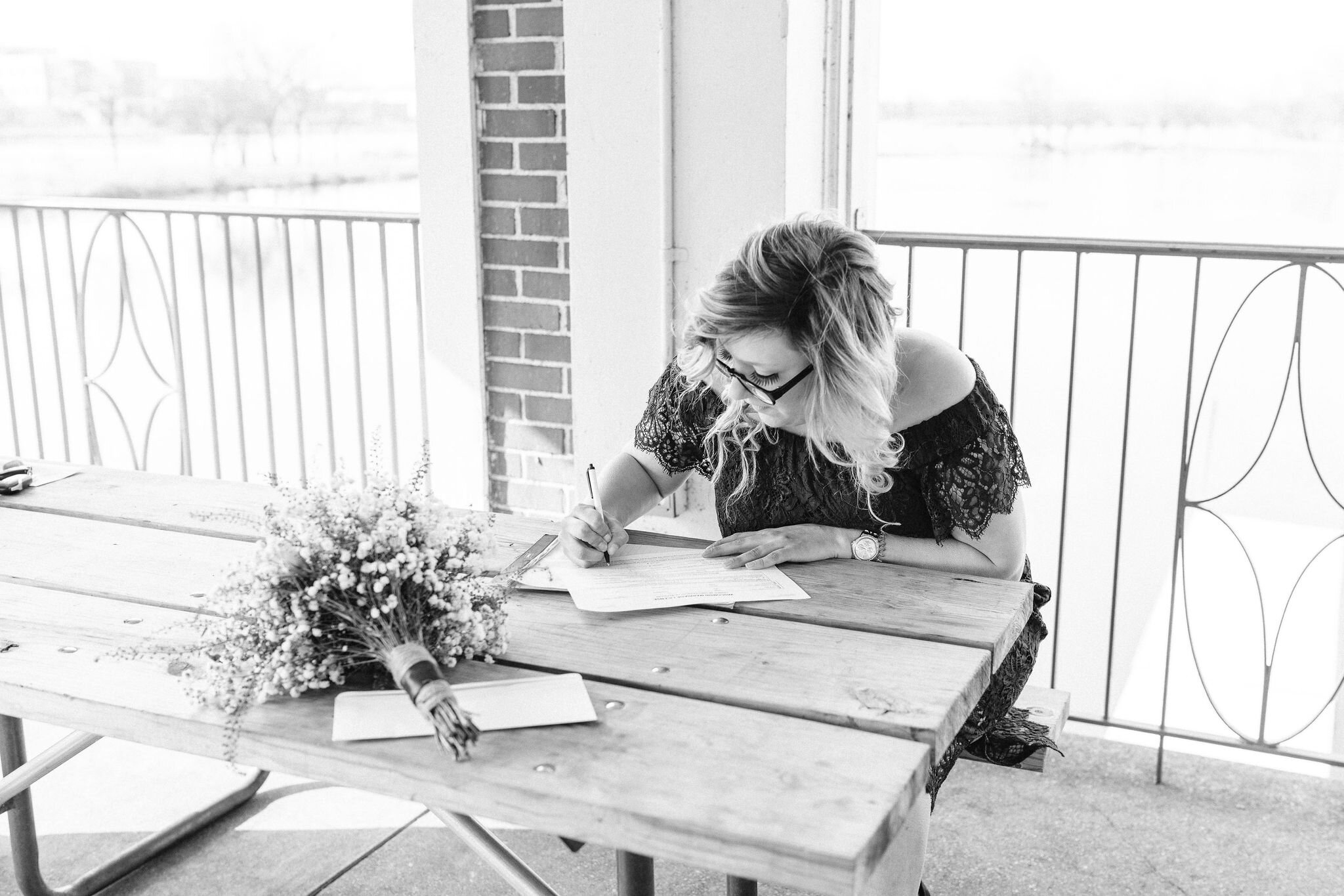 Maid of honor signing the marriage license