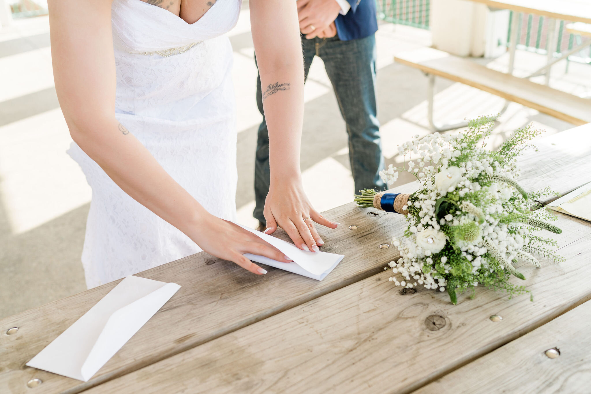 Bride folding the marriage license