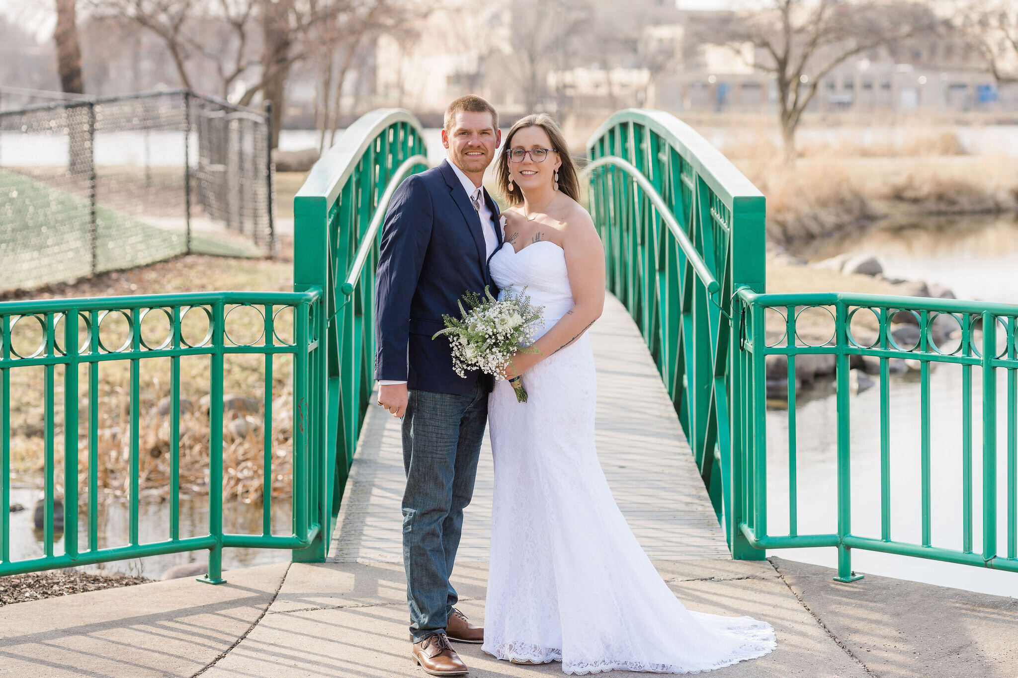 Bride and groom in front of a bridge