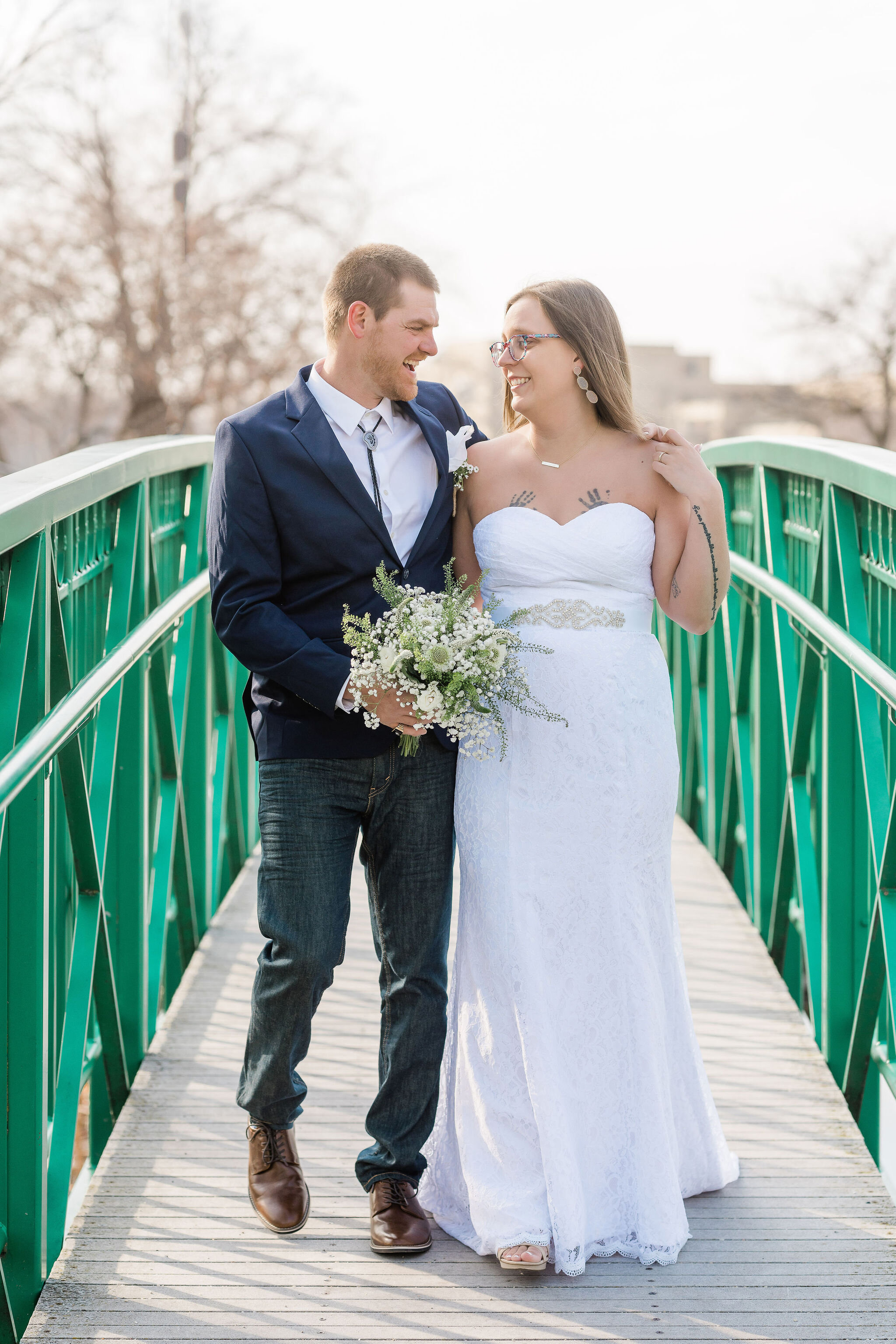 Bride and groom walking on a bridge