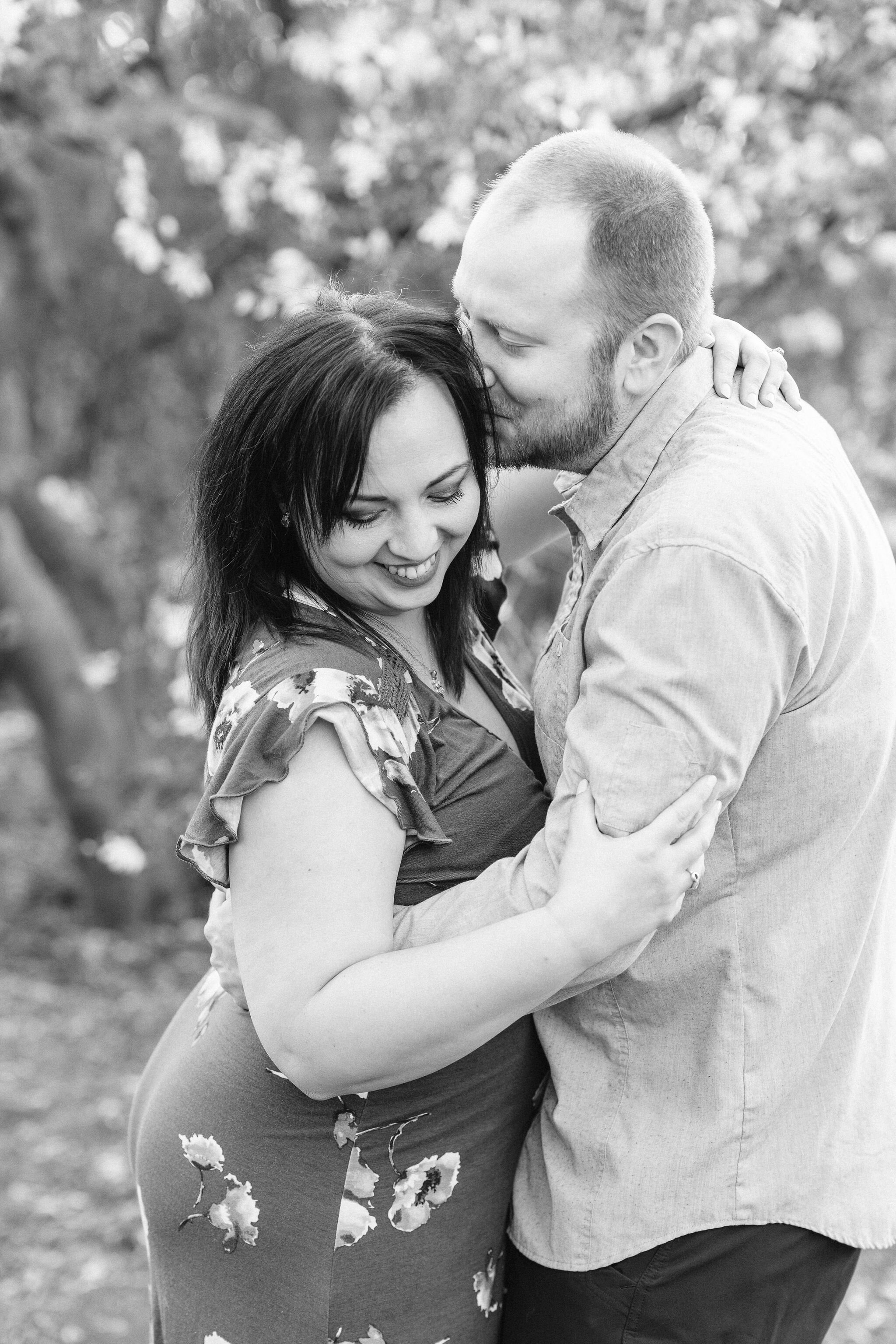 Man whispering into his fiancé's ear