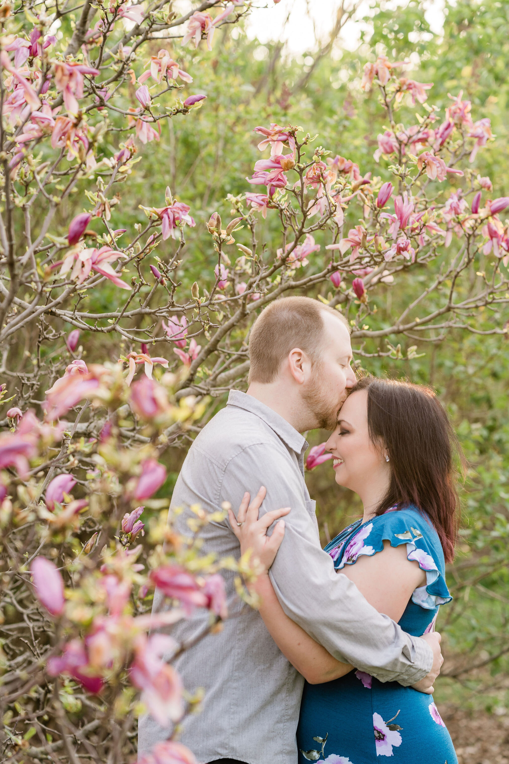 Man kissing his fiancé's forehead