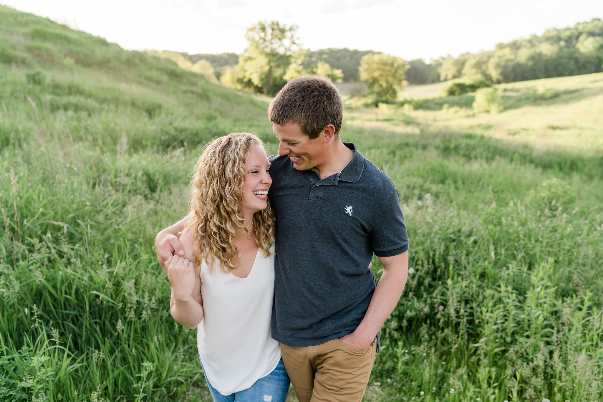 Engaged couple walking arm in arm