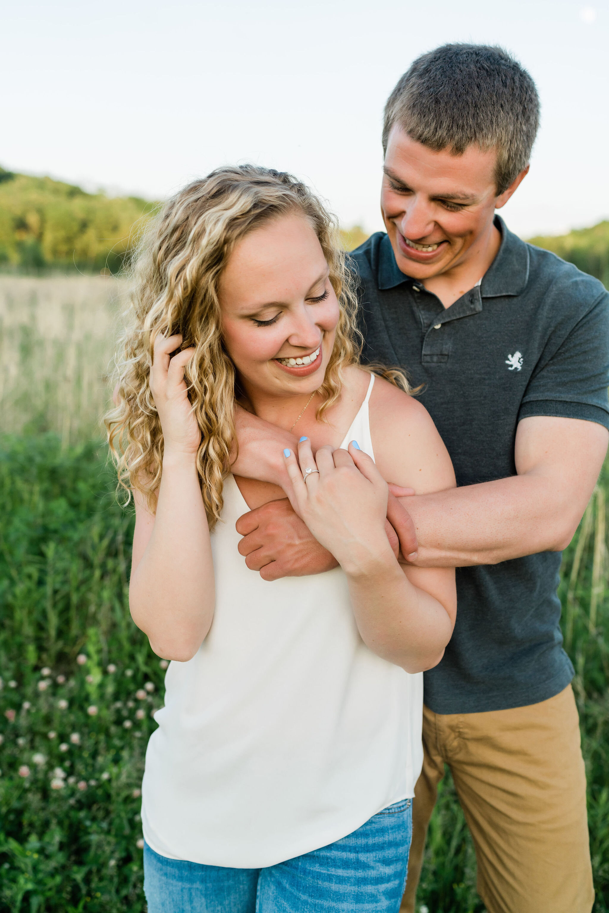 Man hugging his fiancé from behind