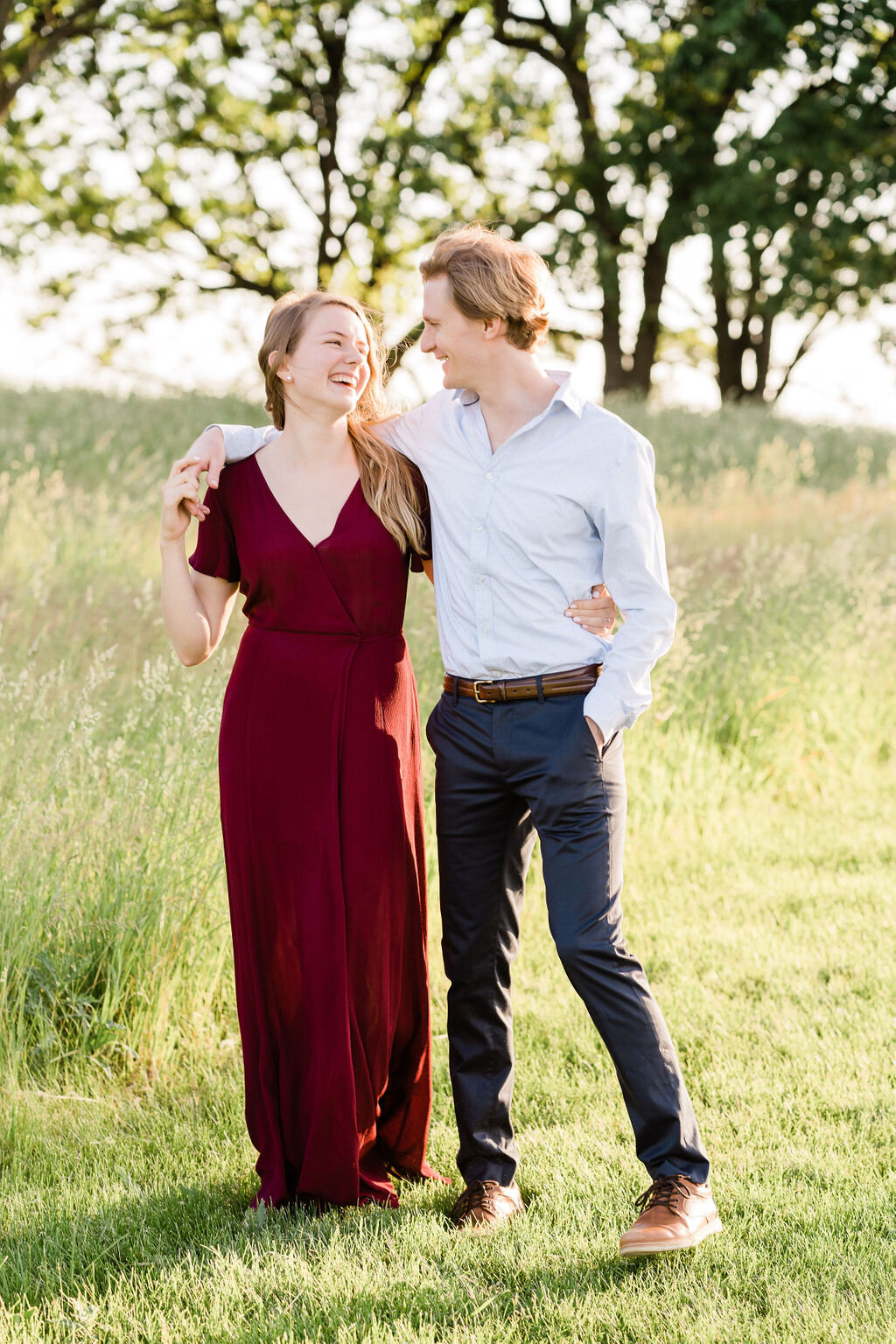 Engaged couple walking in a field