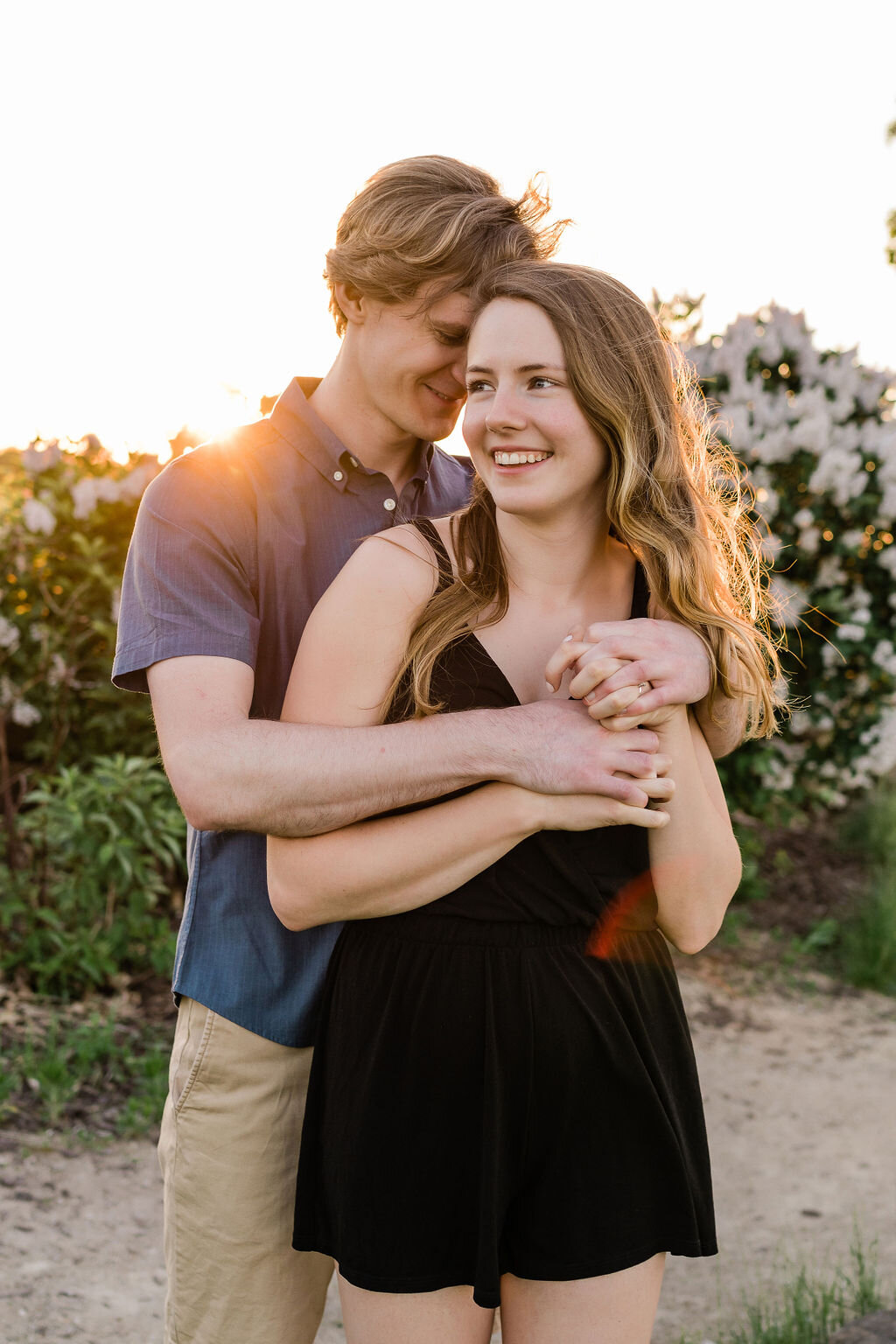 Man hugging his fiancé from behind