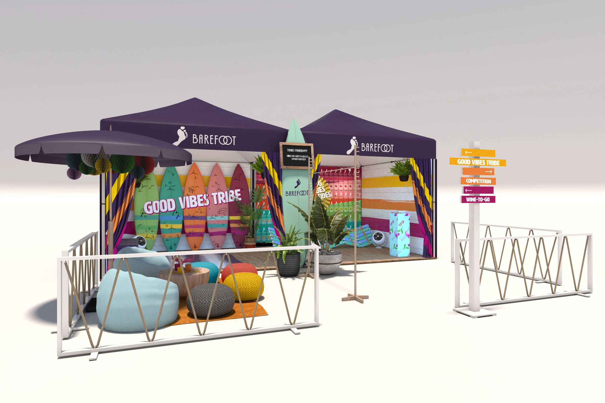 A colorful outdoor booth with surfboards, seating area, and signage for 'Barefoot' and 'Good Vibes Tribe' at a pop-up event.
