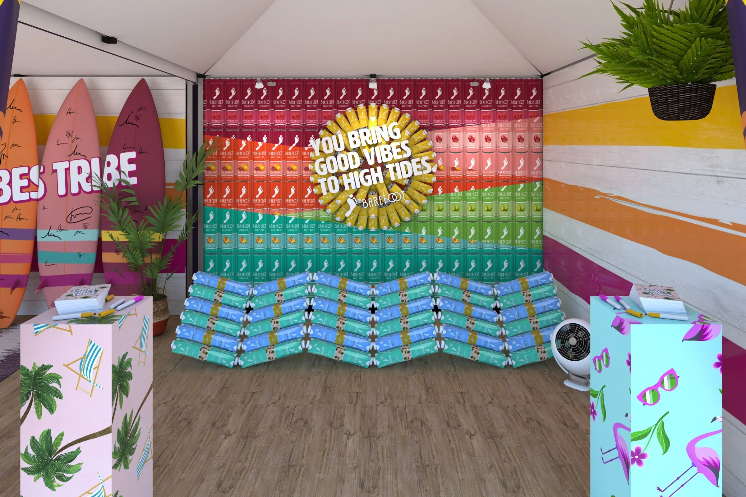Decorative display of surfboards, colorful cans, plants, and signs with a message about good vibes and high tides in a booth or shop setting.
