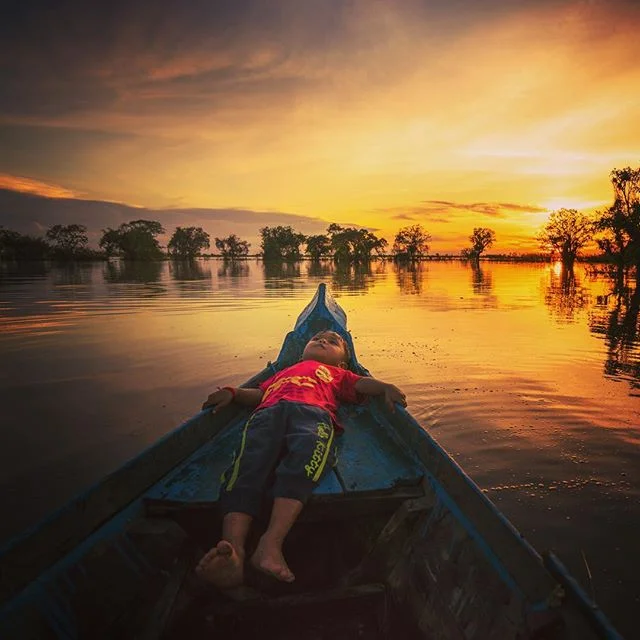 The personal side of Cambodia. The son of a woman who offered to give a ride around her village seeing nothing more than my curiosity and my camera. The language barrier made it difficult but I felt just like this little dude, completely at ease in a
