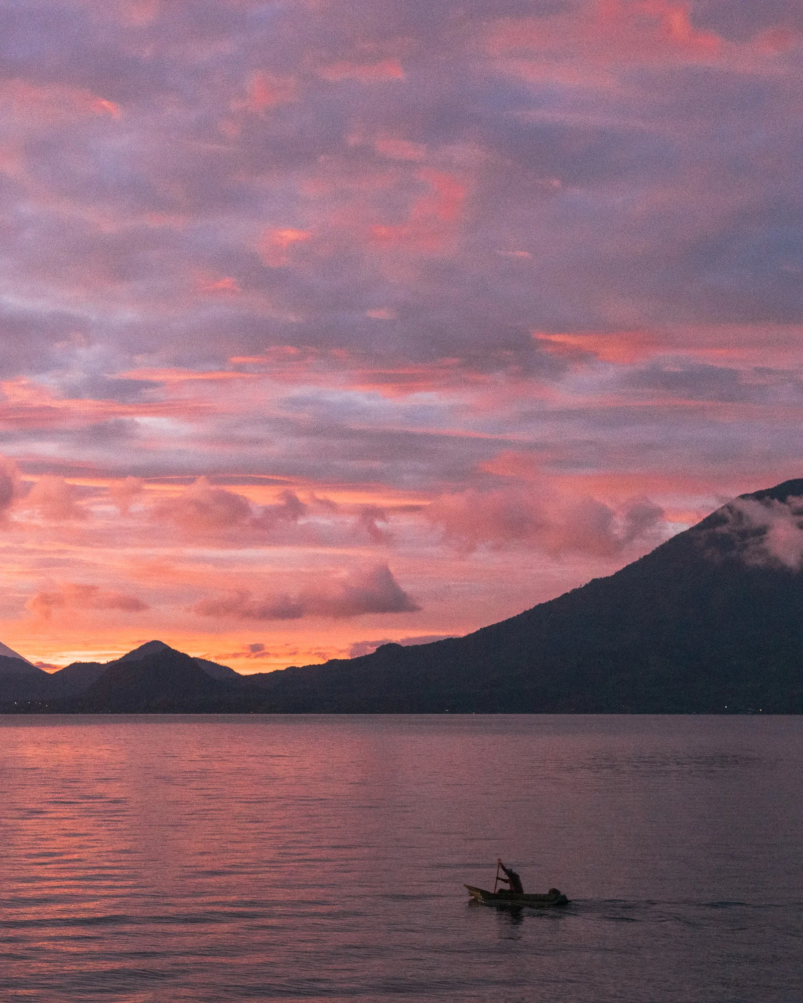 Sunset at Lake Atitlan with a view over the Water and a local fischerman