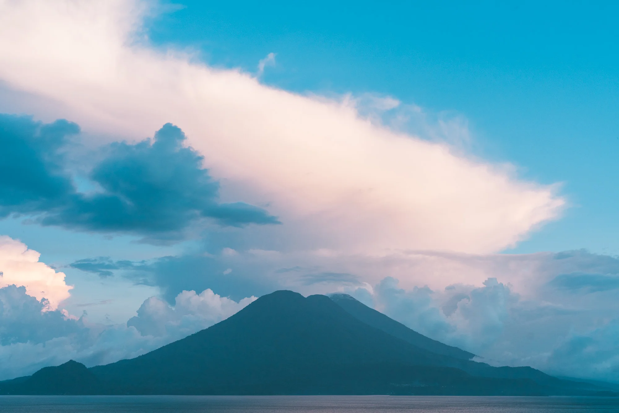 volcanos with big clouds at lake atitlan