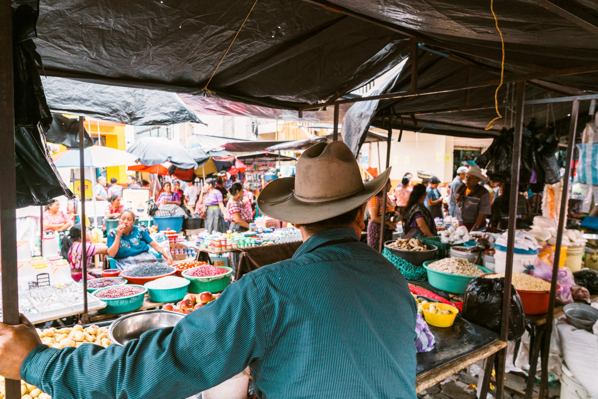 man selling goods at the sunday market at lake atitlan