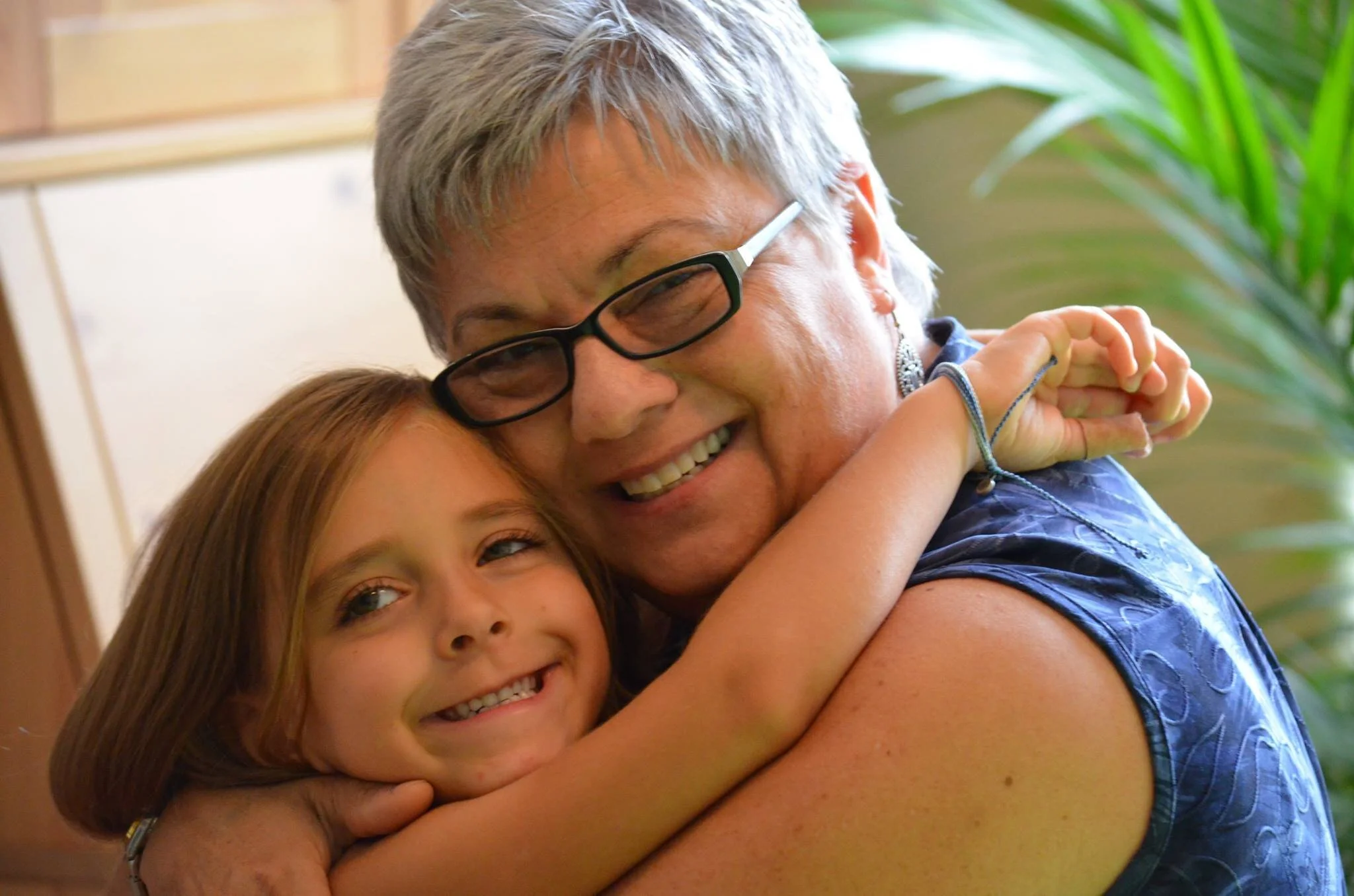 photo of Mary hugging her young granddaughter, both smiling