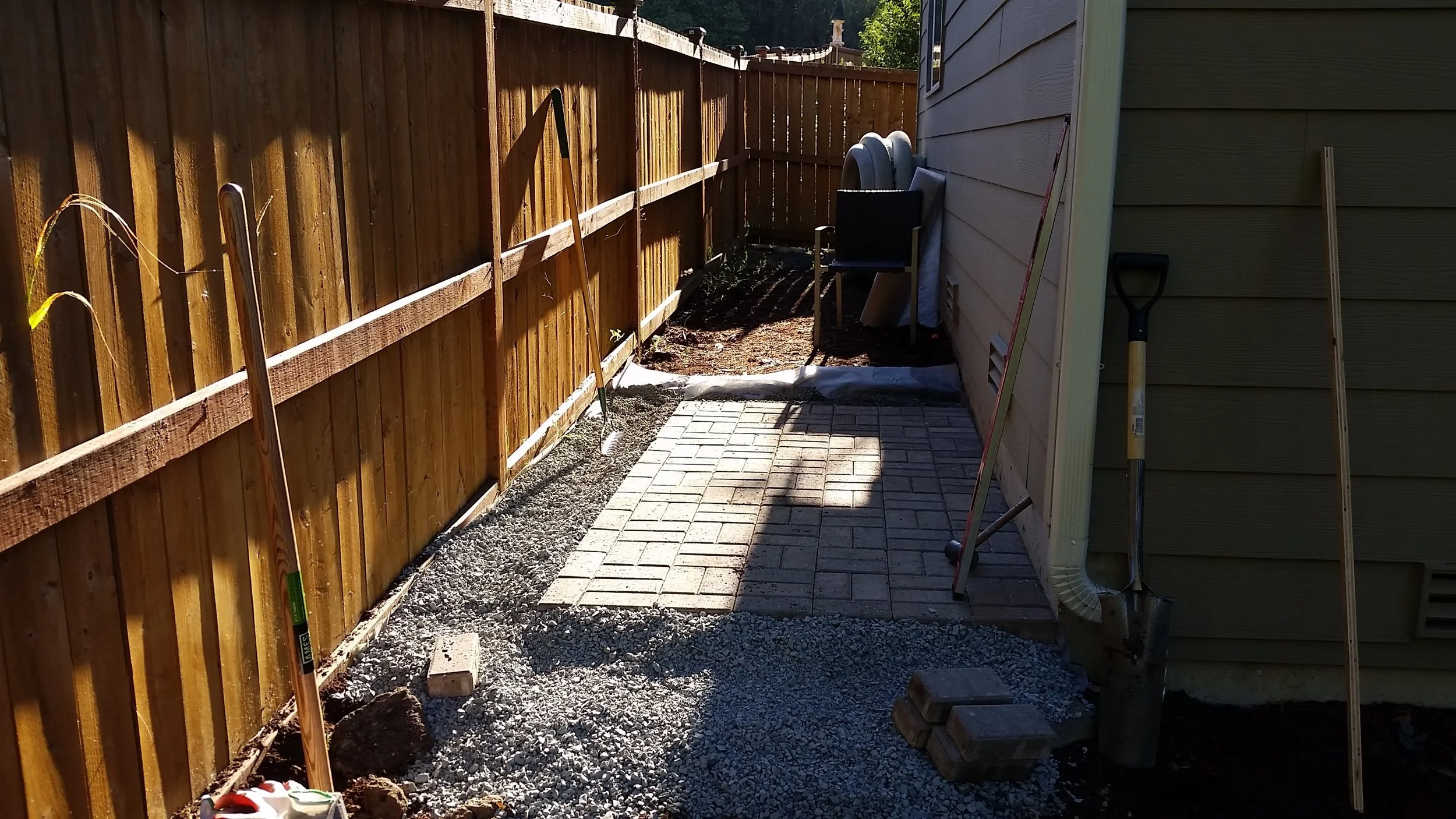I've had some salvaged pavers stacked behind the house for about a year, so this was the perfect opportunity to put them to use. Any good shed needs a solid pad foundation.