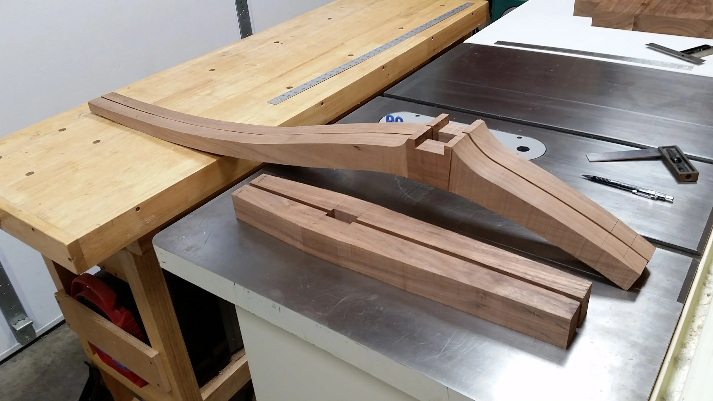 After some simple layout lines, I cut tapers into the edges of the front and rear legs using the bandsaw.