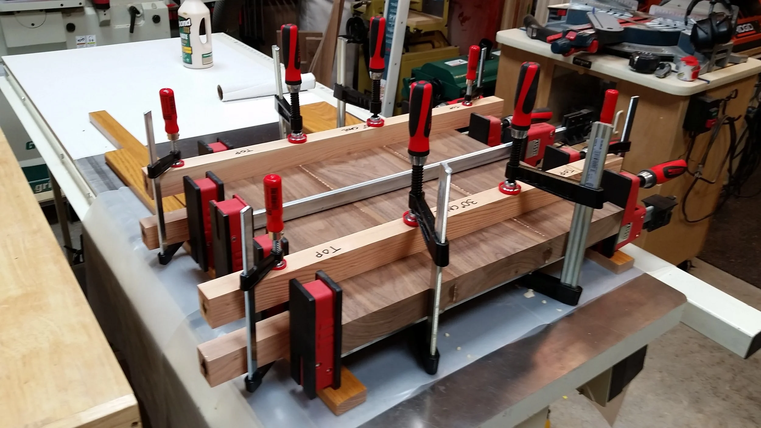 Seat boards clamped and aligned with the clamping cauls.