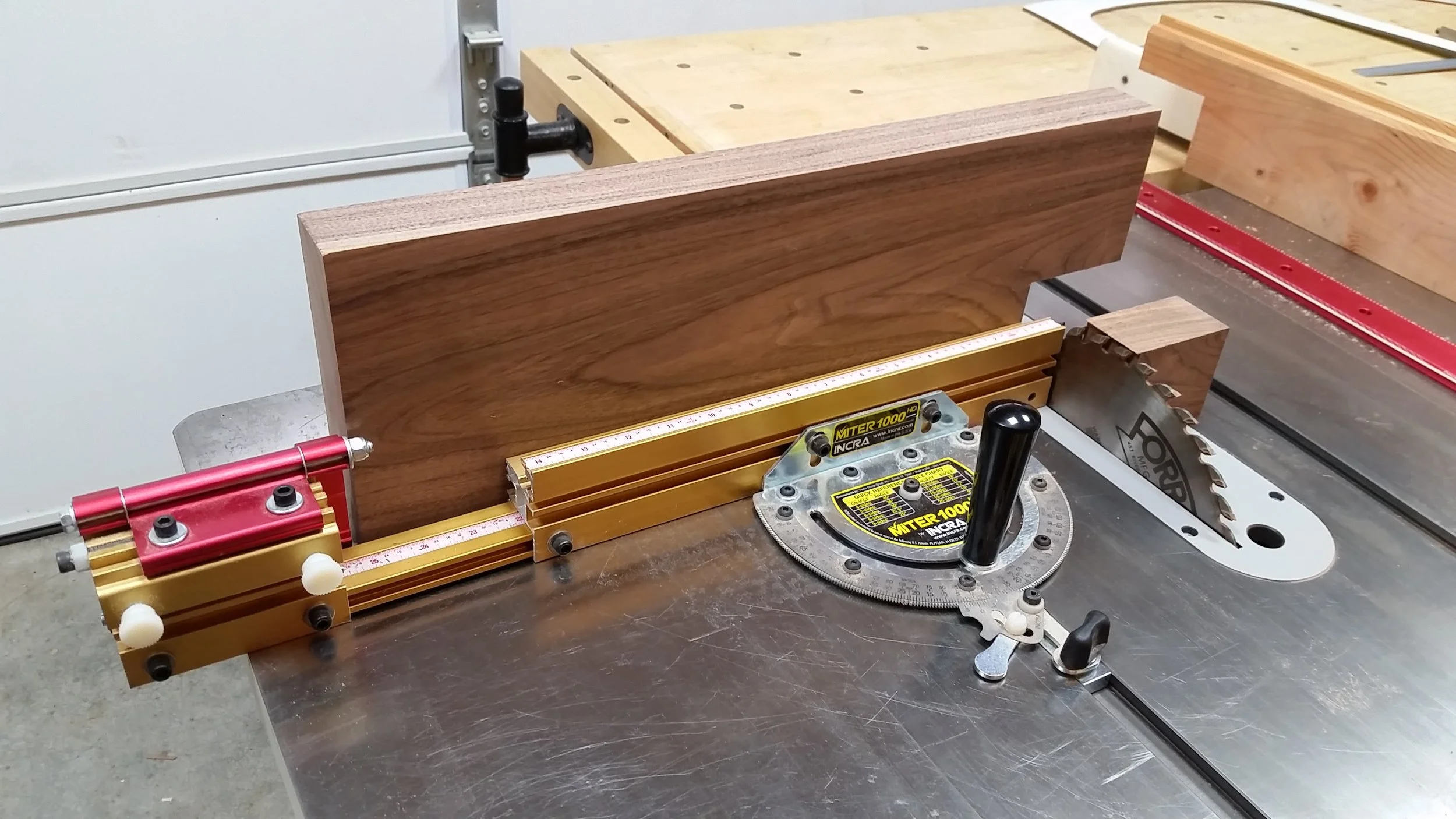 Using the miter gauge on the table saw to make the second cut in each of the outside seat boards to finish off the rear leg notches.