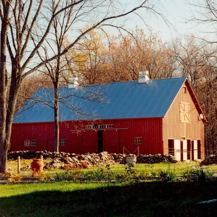 Farm vernacular meets modern design. In our Colonial Farmhouse project, we had the privilege of relocating a circa 1840 timber frame hay barn from Ontario, Canada, to Stone Ridge, NY, where it was meticulously reconstructed and repurposed for riding 