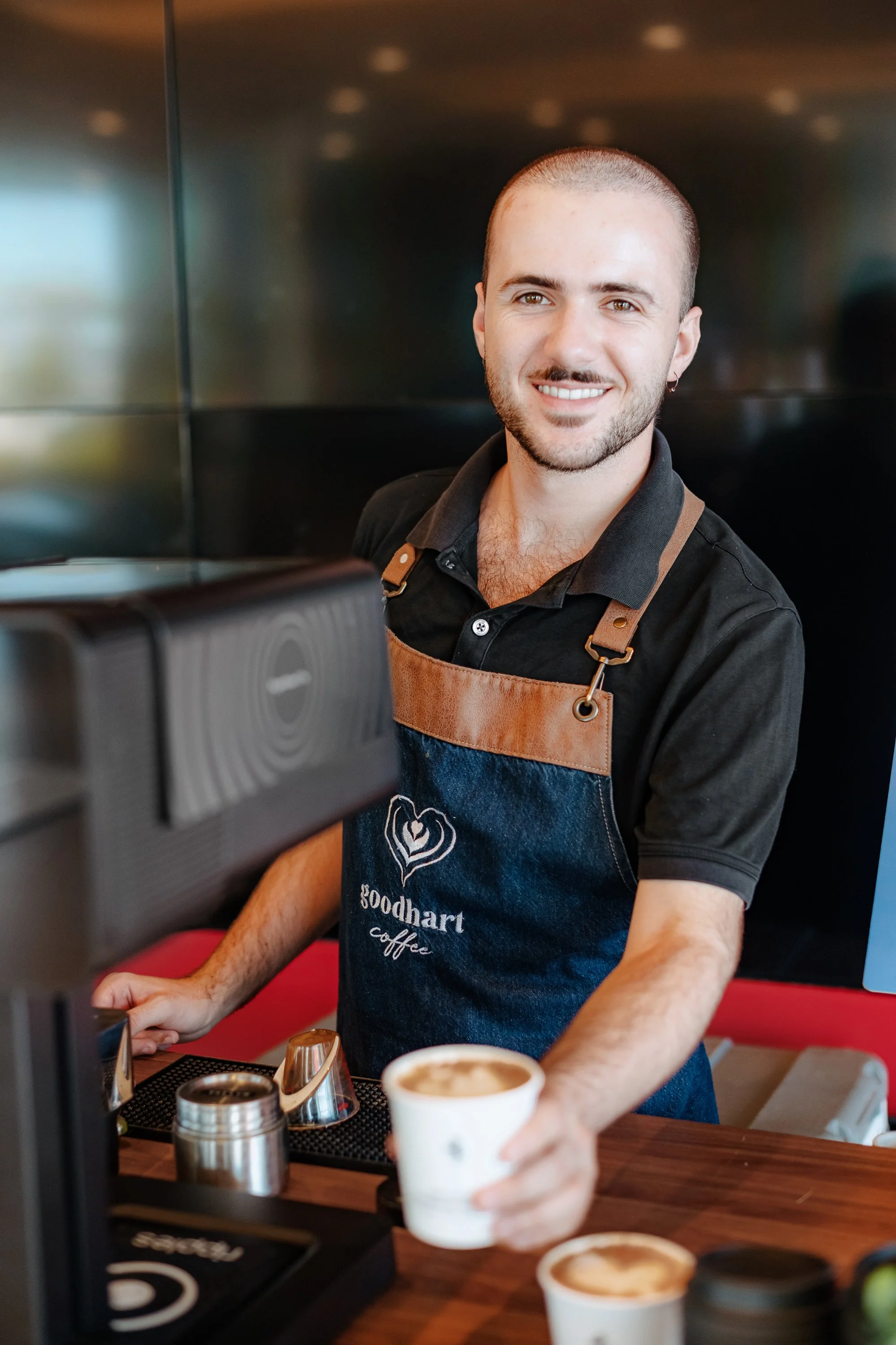 A friendly and polished barista serving guests in Levittown, reflecting the five-star professionalism and personable service that make the experience memorable.