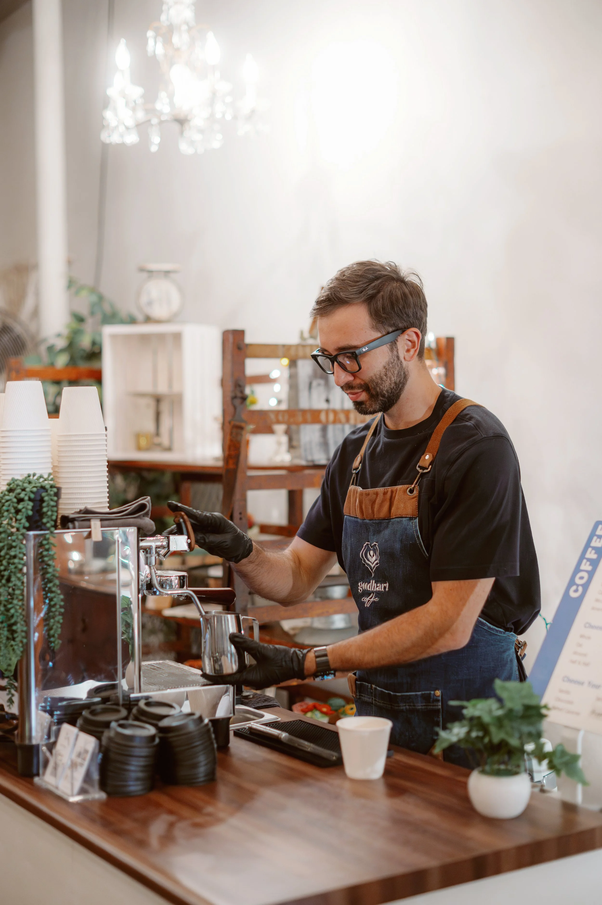 A friendly and polished barista serving guests in Plano, reflecting the five-star professionalism and personable service that make the experience memorable.