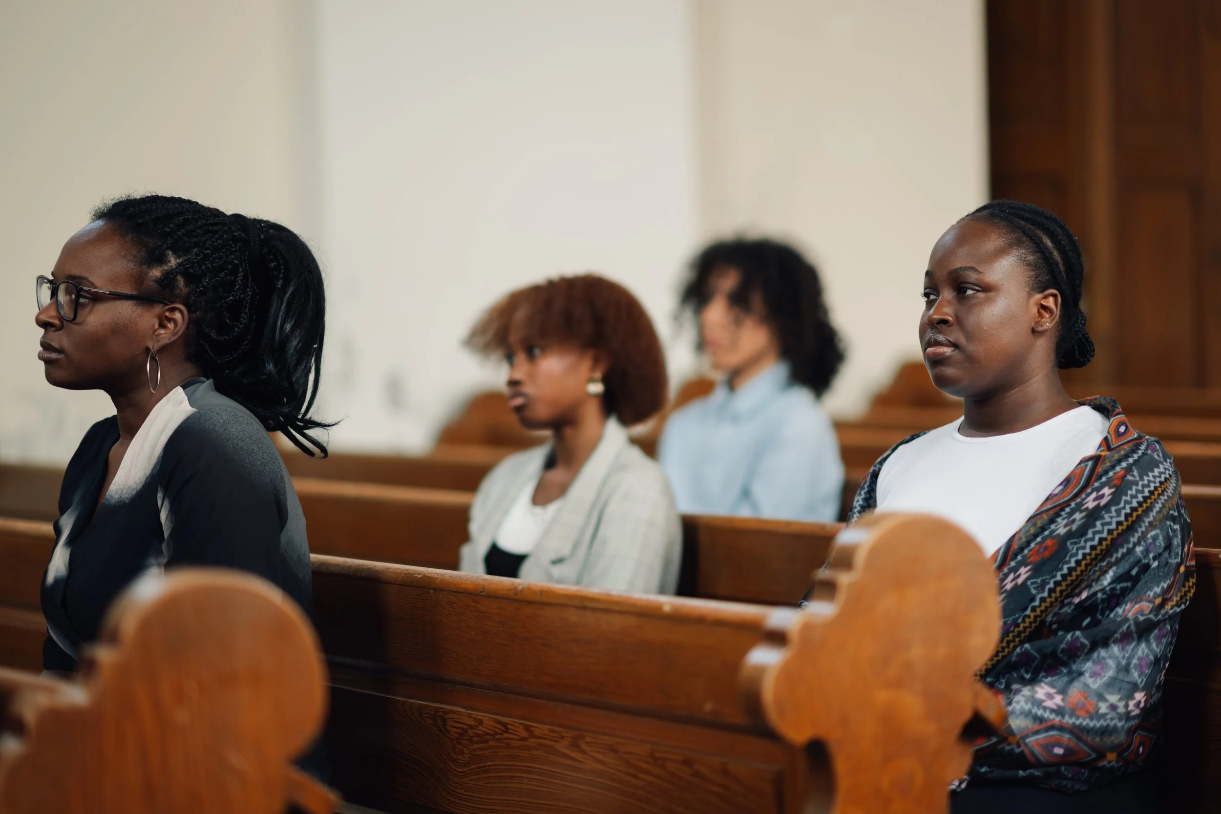 young-black-people-sitting-in-church-pews-listenin-2024-10-03-00-49-23-utc.jpg