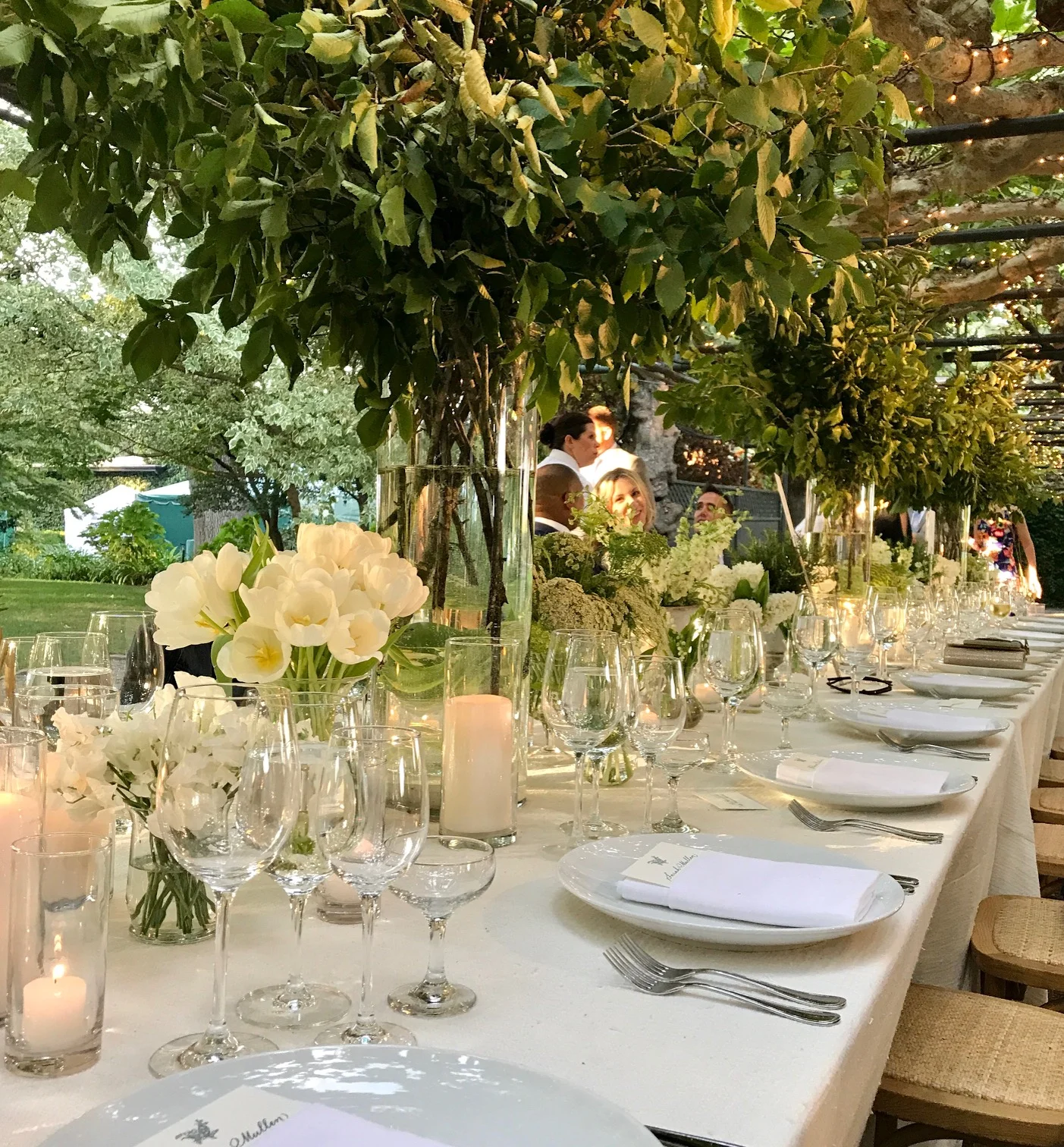 A tablescape to remember. Varying sizes of green and white flowers grace the tables of the bride & groom's friends and families. 