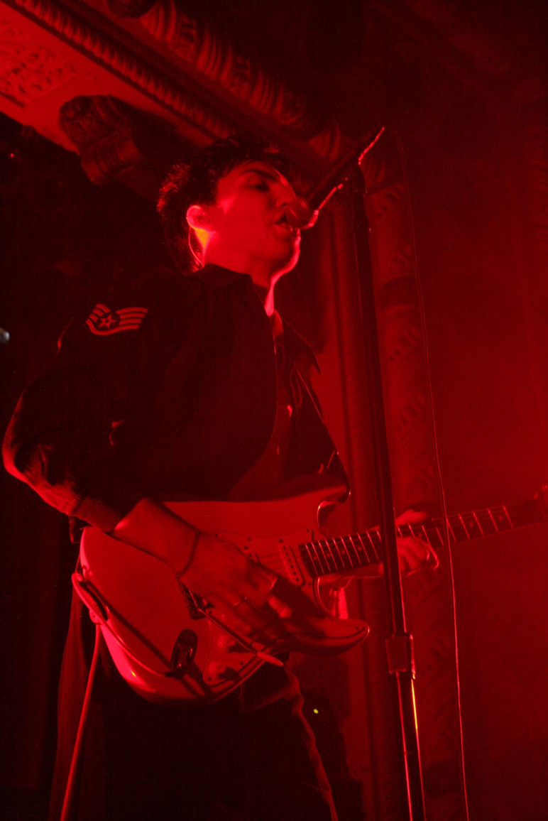 Photo by Gemma Joosse. Bowman sings to the crowd, clad in a military-esque jacket and tuxedo pants.