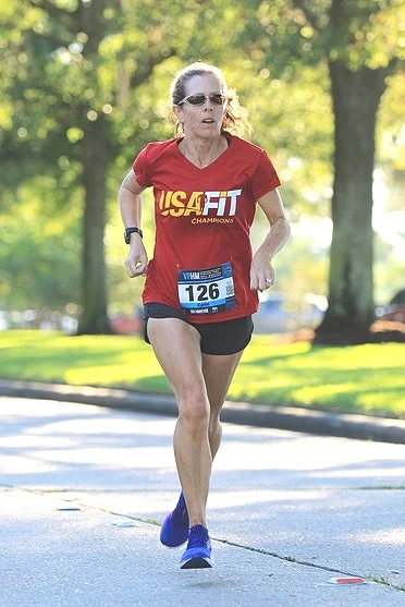 Karen flying through the air on one of her many marathon races