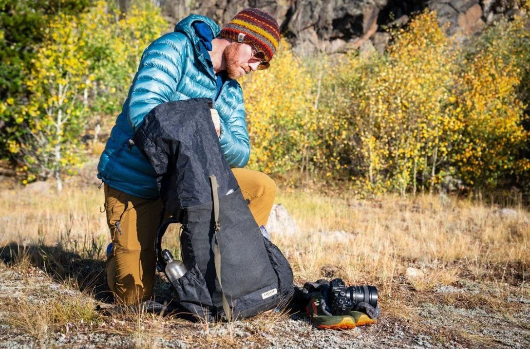 hiker filling up pack.jpg