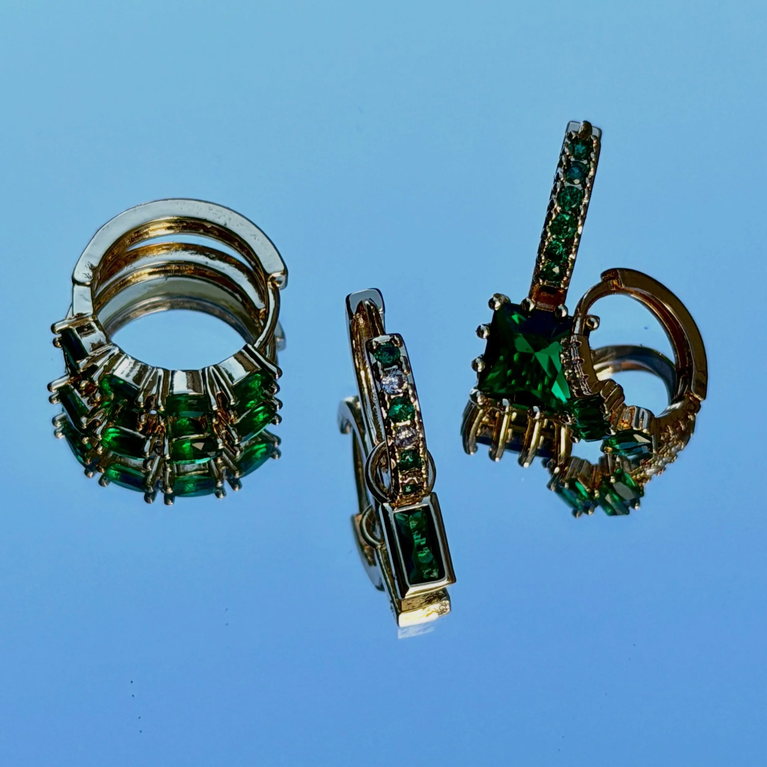 Green doesn&rsquo;t compete for attention. It commands it.
Pav&eacute; mini hoops. Basket Bezels. Dangle hoops- each one designed to move with you.

Inspired by sunlit jade gardens, coastal cliffs, and hidden emerald coves, each piece brings summer&r