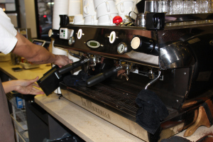 The portafilter is then attached to the Espresso Machine, which pumps water through the portafilter.