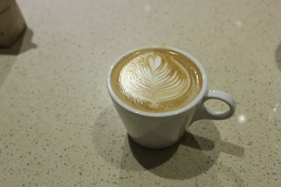 Latte with a signature barista steamed milk “latte art.”