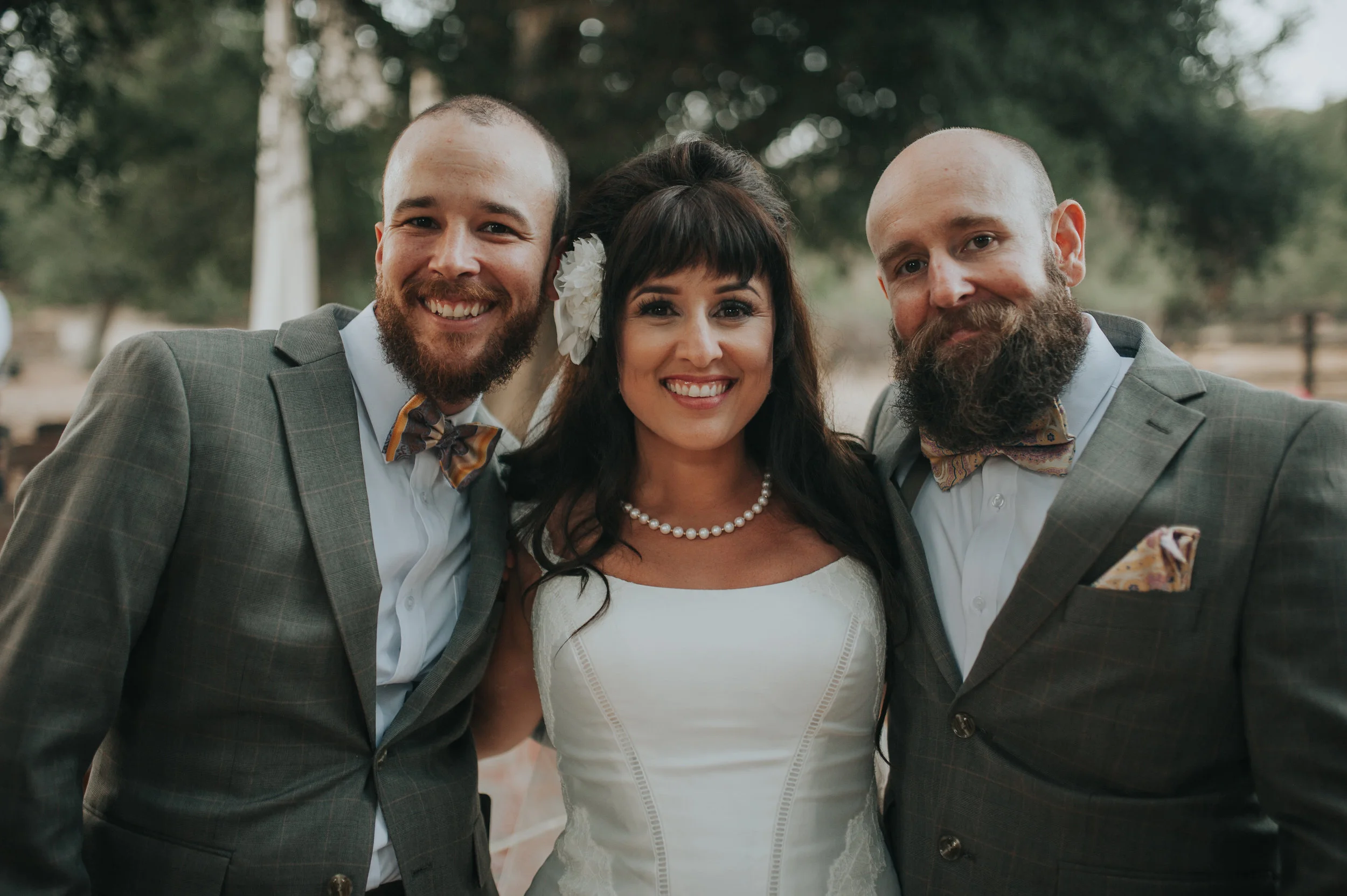 Bride wearing Zac Posen with her two brothers as they walk her down the aisle in the Temecula Valley.