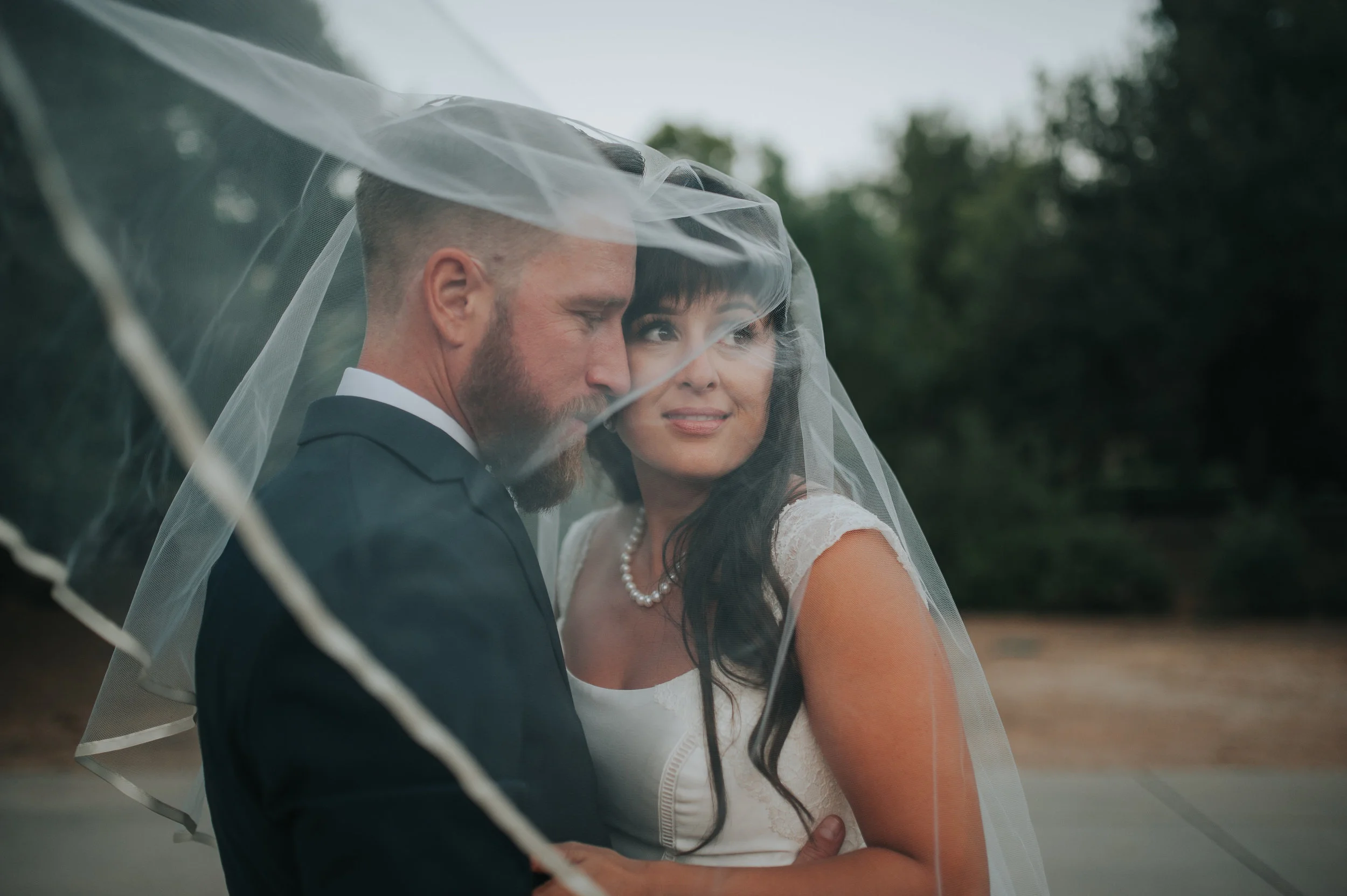Bride and groom under the brides veil in the Temecula Valley.