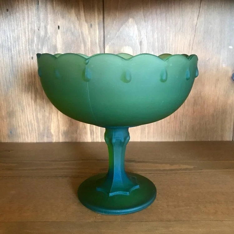 Cloudy olive green glass mid century modern compote with tear drop edge. Wedding rentals in Murrieta.