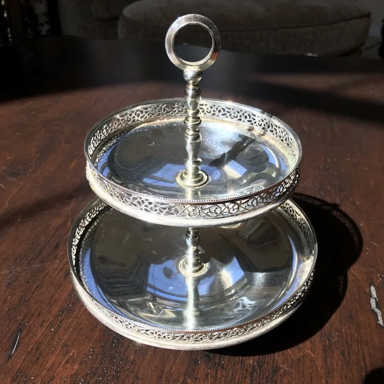 Silver Two Tiered Tray Fancy. Vintage silver plated two tiered serving tray with lattice edges and a round handle. 10" tall x 7" bottom, 5.5" top. Cute as a button!