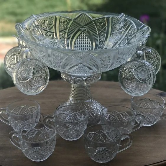 Punch Bowl Set. Cut glass punch bowl on a decorative base. Comes with 10 matching cups.