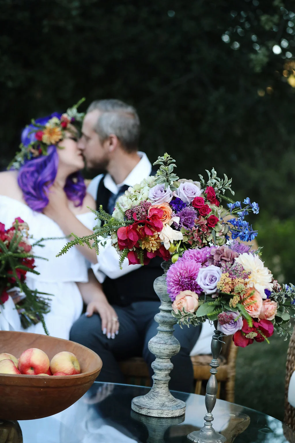 Tall colorful floral arrangements found on a mid century modern table during a bridal photo shoot. The bride had fabulous ultra violet hair. Location was Chateau Adare in the Temecula Valley.
