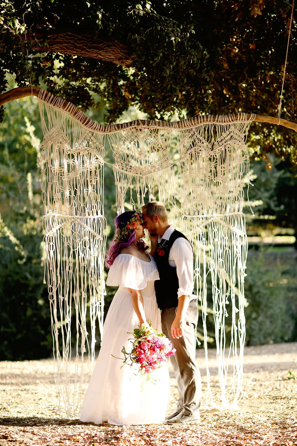 Handmade macrame backdrop hanging from oak trees at Chateau Adare in Murrieta.