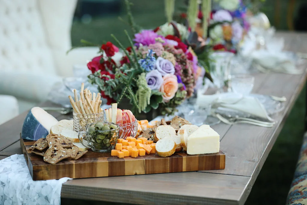 Custom charcuterie board on top of our industrial farm table set for the wedding party. Rentals from Birdie in a Barn vintage rentals in Murrieta.