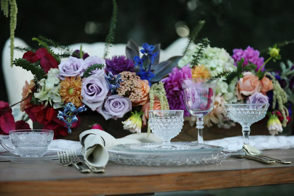 Vintage cut glass by Anchor Hocking set on an Industrial Farm table for a wedding party.